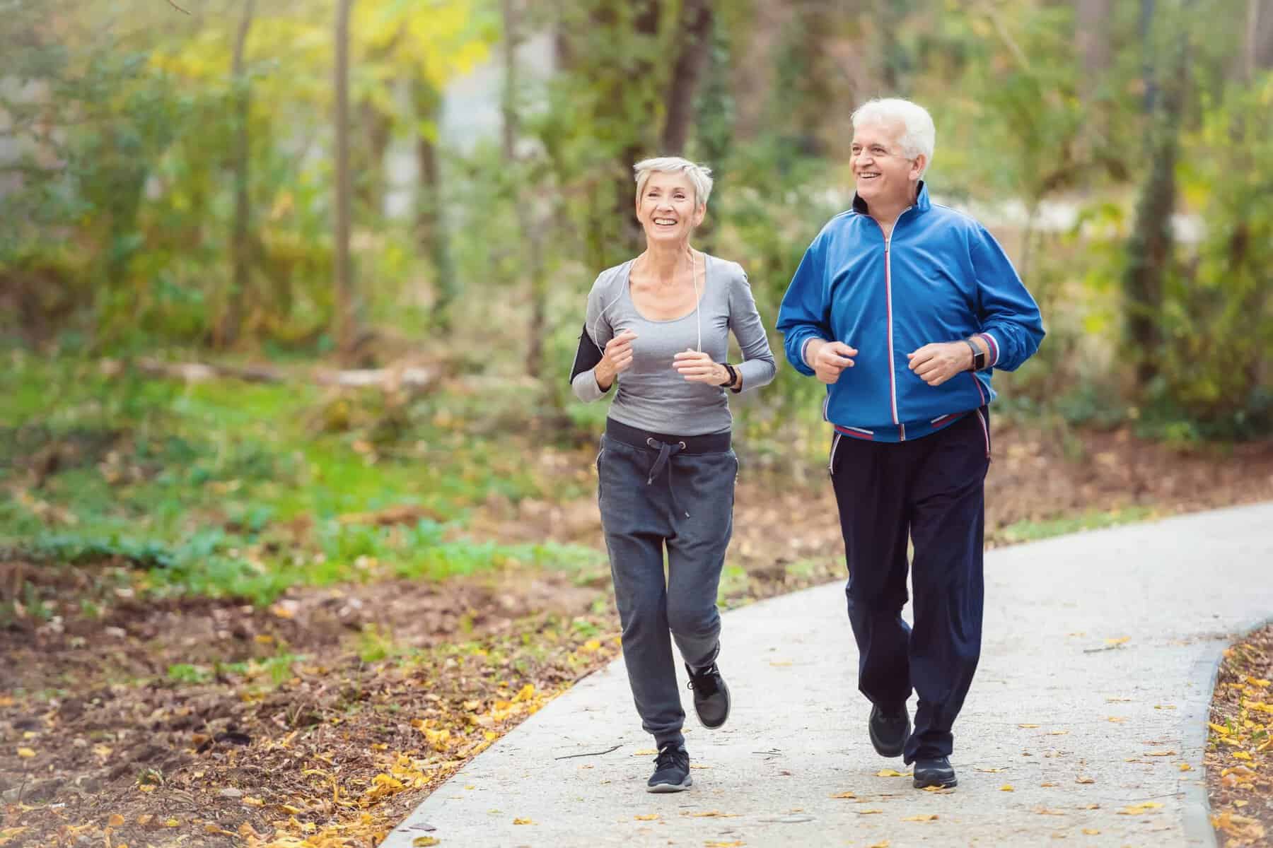 older woman and man out jogging for exercise